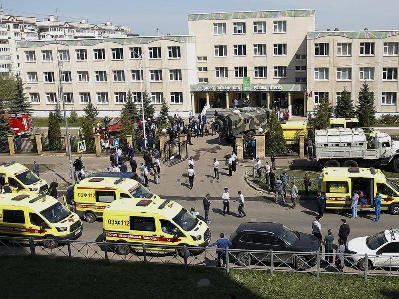Emergency vehicles attend the school in Kazan where at least eight people have been killed.