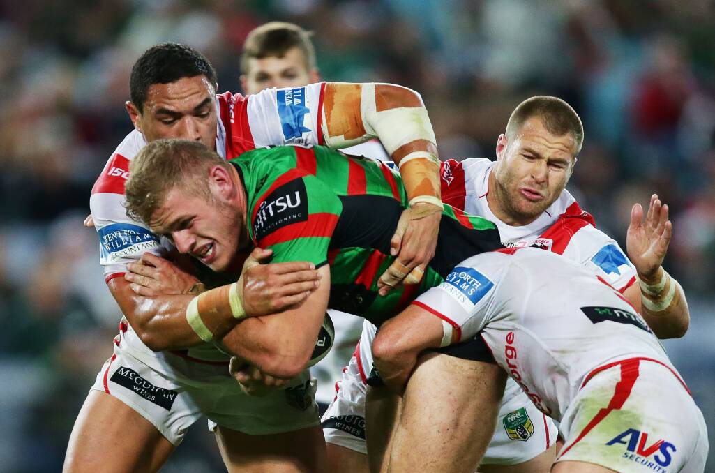 Rabbitohs forward Tom Burgess charges into the Dragons defence during the NRL match at ANZ Stadium on Monday night. Picture: GETTY IMAGES