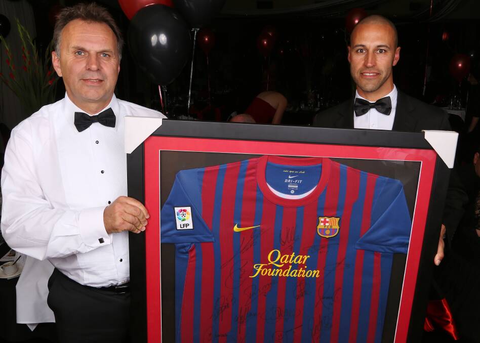 Val Perkovic and Alfredo Mousinho-Esteves with the signed Barcelona jersey. Picture: GREG ELLIS