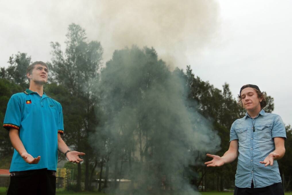 The Illawarra Koori Men's Support Group and Southern Youth and Family Services (SYFS) have joined together and developed a program that provides housing and support to young Koori men. Program participants Ryan Carlson, 18, and Nathan Price, 18, take part in a cleansing smoke ceremony at the program's launch. Picture: SYLVIA LIBER