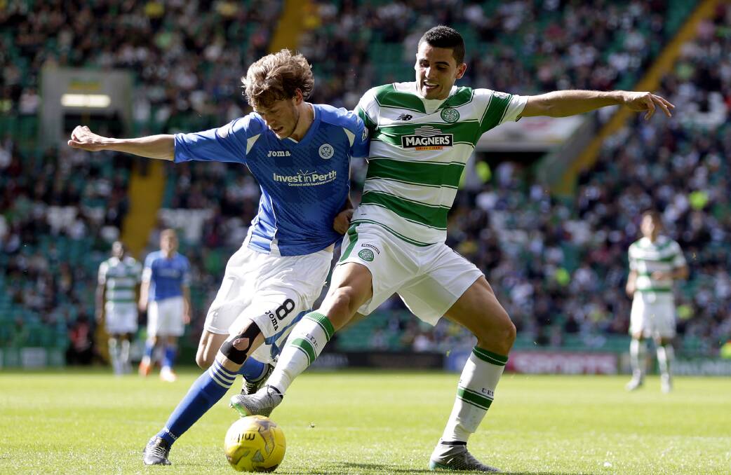 Celtic’s Tom Rogic, right, tussles with St Johnstone’s Murray Davidson. The Socceroos are praying he stays injury free.  Picture: REUTERS
