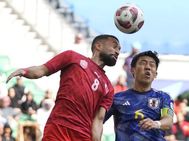Wataru Endo (right) competes for the ball in Japan's Asian Cup round-of-16 win over Bahrain. (AP PHOTO)