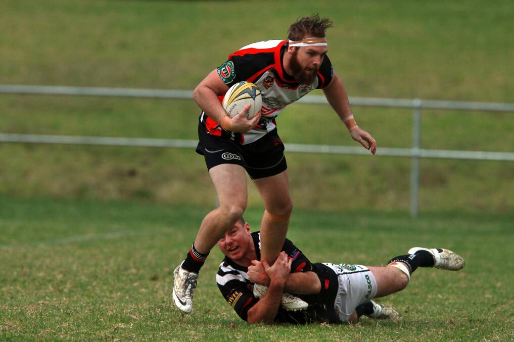 Kiama's Jacob Dolan is tackled by a Port Kembla defender on Sunday.Picture: SYLVIA LIBER