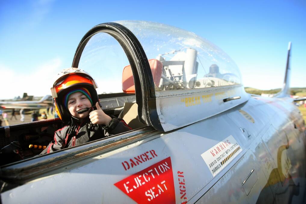 Joshua Cato, 5, of Wollongong in a Sabre Jet, and one of the  F/A-18 Hornet fighters able to withstand the weather. Picture: SYLVIA LIBER