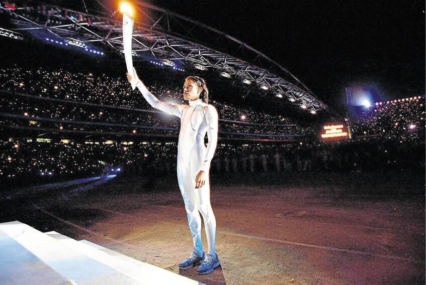 Cathy Freeman prepares to light the Olympic flame during the opening ceremony of the Sydney 2000 Olympic Games. The suit she was wearing had been missing for more than a decade. Picture: GETTY IMAGES