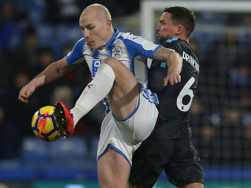 Aaron Mooy (L) is a hope of playing in Huddersfield's home clash against Manchester United.