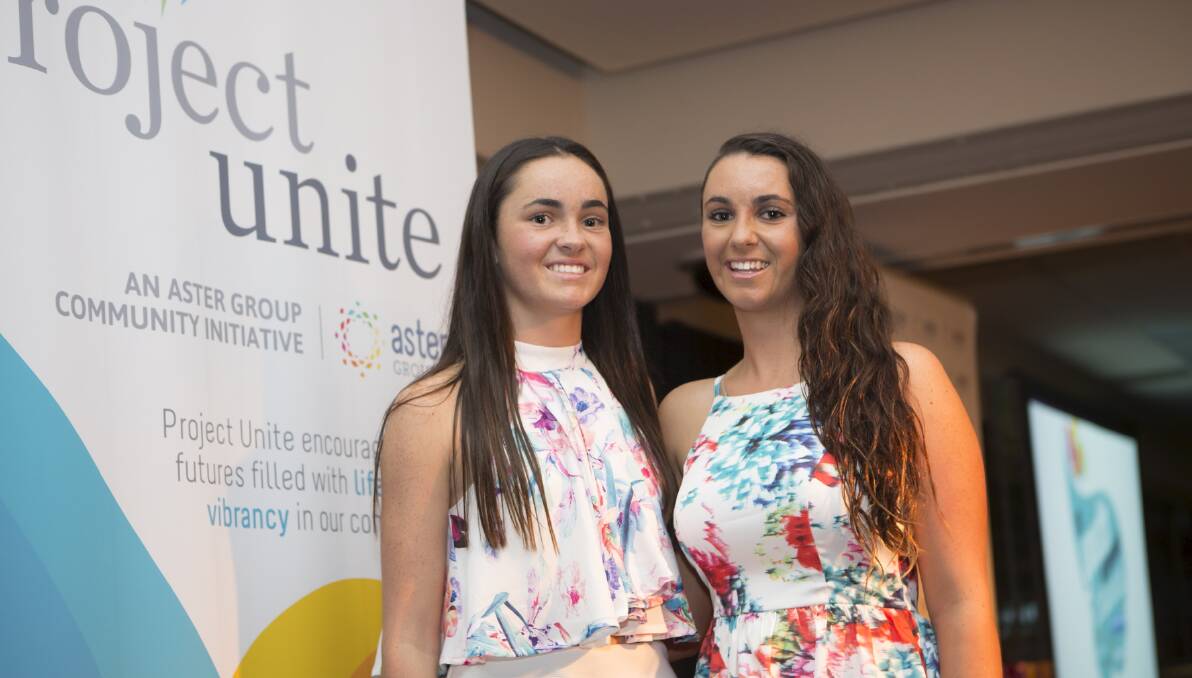 Parental support: Meghan Fox, left, and her sister Shannon at the Illawarra Youth Achievement Awards. Meghan was joint winner of the Junior Academic category and Shannon runner-up in the Citizenship category. Picture: MARK NEWSHAM