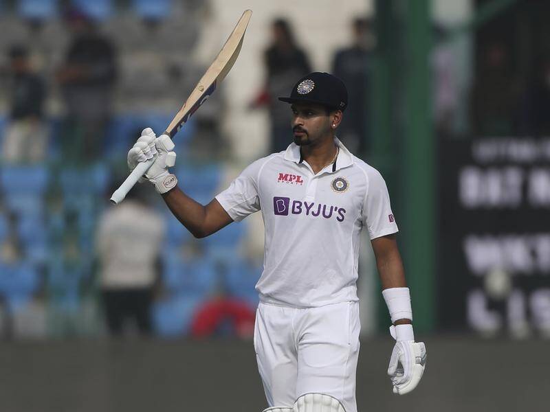 Shreyas Iyer raises his bat after reaching 50 in the second innings of his brilliant Test debut.