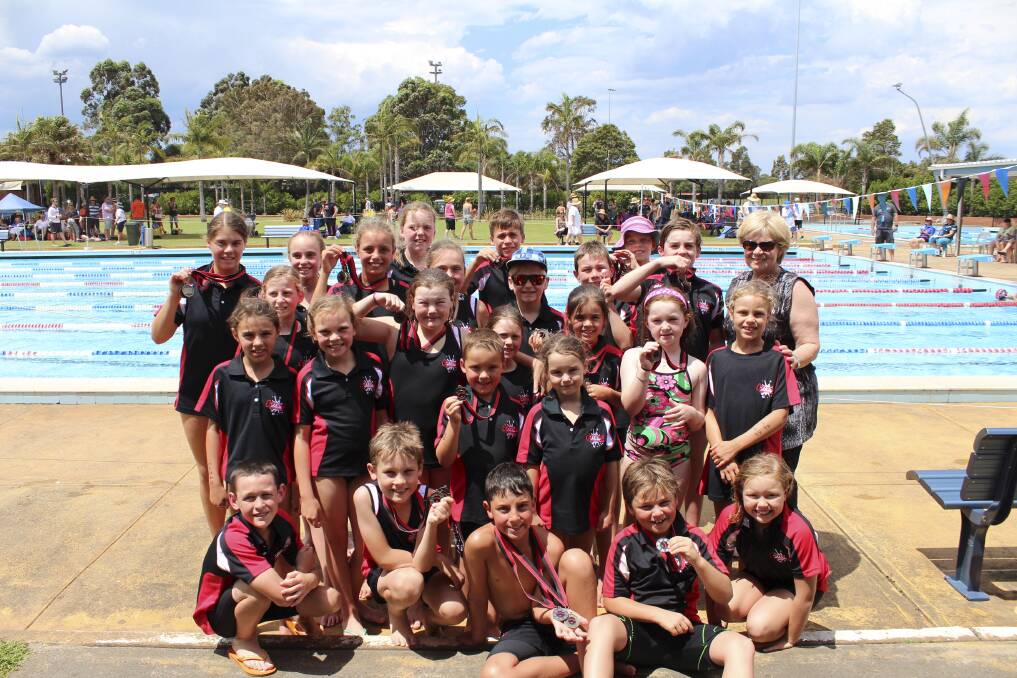 Poolside: Corrimal Swim Club juniors take time out at the Summer Qualifying Carnival.
