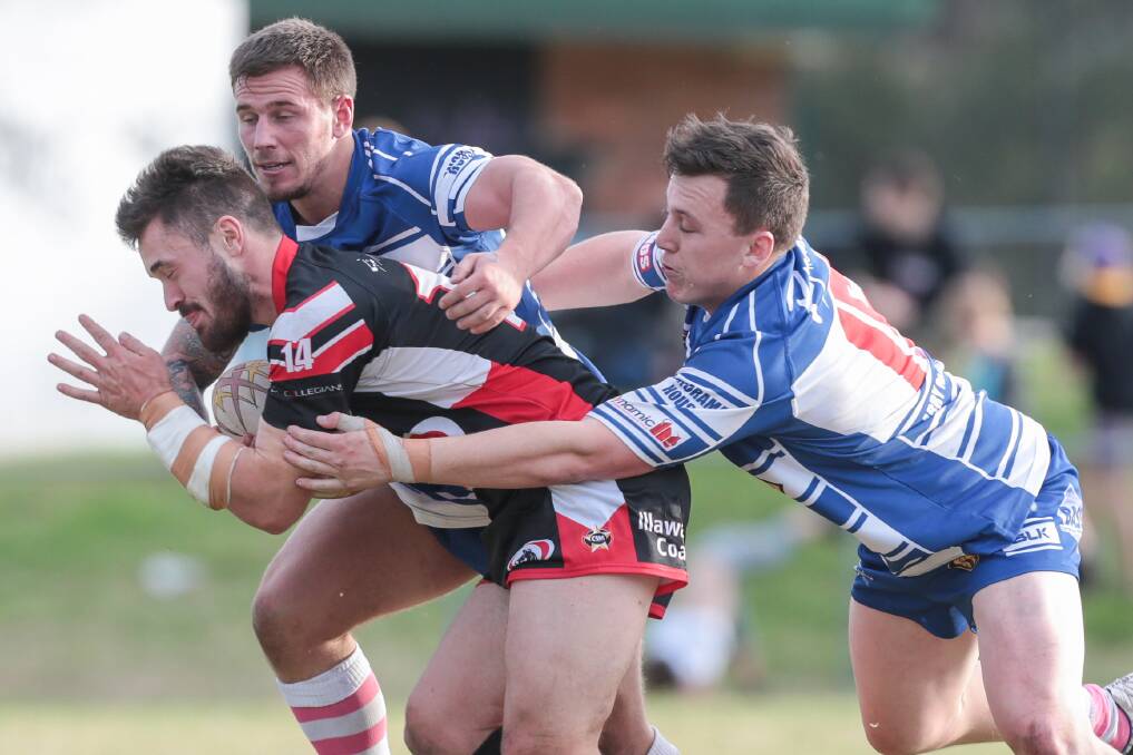Collegians' Daniel Burke is heavily marked by Thirroul at Gibson Park on Sunday. Picture: ADAM McLEAN