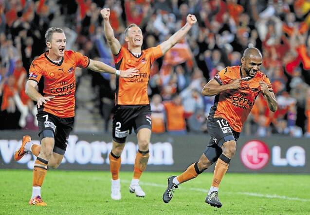 Pure bliss: Brisbane Roar's Besart Berisha, left, and Henrique, right, celebrate on Sunday night. Picture: GETTY IMAGES