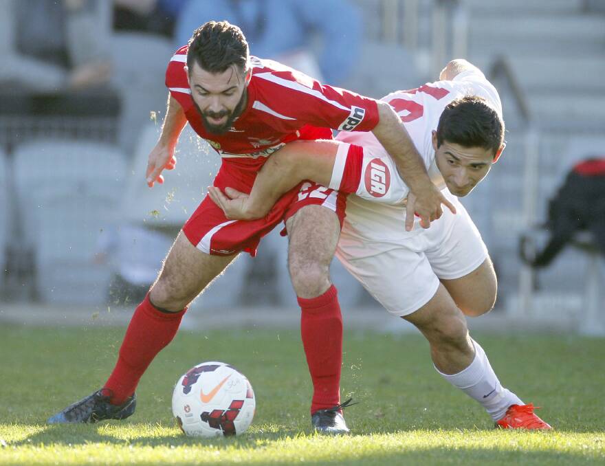 Wolves' Samuel Matthews grapples with Jonathan Castano-Acero of the Saints on Sunday. Picture: ANDY ZAKELI