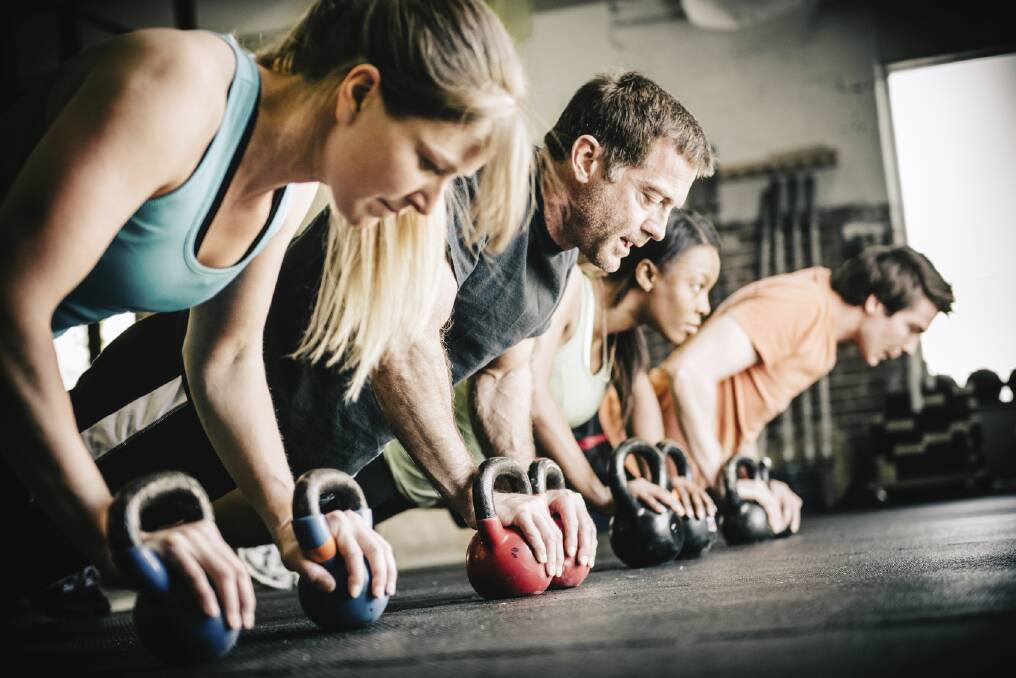 CrossFit workouts mix lifting weights such as kettlebells, with pull-ups and cardio - with the aim of doing as many rounds of reps as possible. Picture: iStock