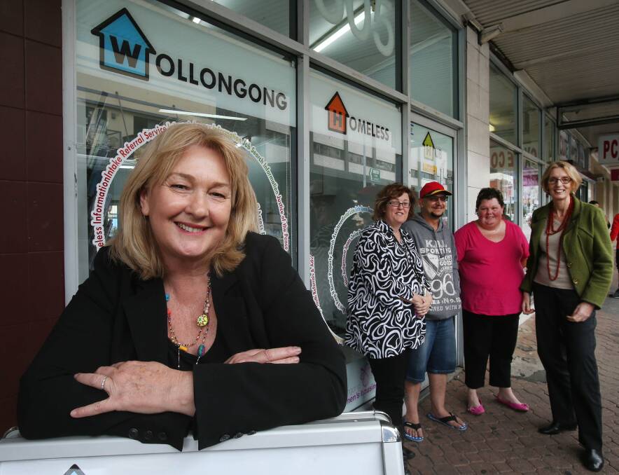 Wollongong Emergency Family Housing manager Julie Mitchell is relieved at the hub's survival. Behind her, hub staff members Kim Brown (left) and Loekie Klevjer (right) share the good news with clients John and Natasha Wyss outside the Crown St Wollongong premises. Picture: KIRK GILMOUR