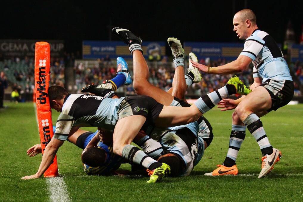Will Hopoate of the Eels is upended during Parramatta's 42-24 thumping of Cronulla on Monday night. Picture: GETTY IMAGES