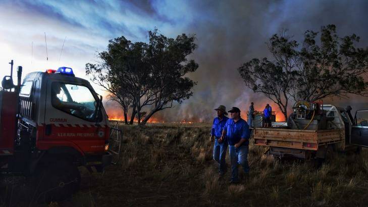 Farmers battle a fire that started with a lightning strike near a larger blaze west of Cassilis. Photo: Nick Moir