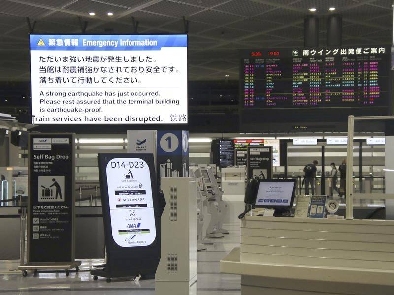 Signs at airports notified travellers a magnitude 6.2 earthquake had shaken eastern Japan. (AP PHOTO)