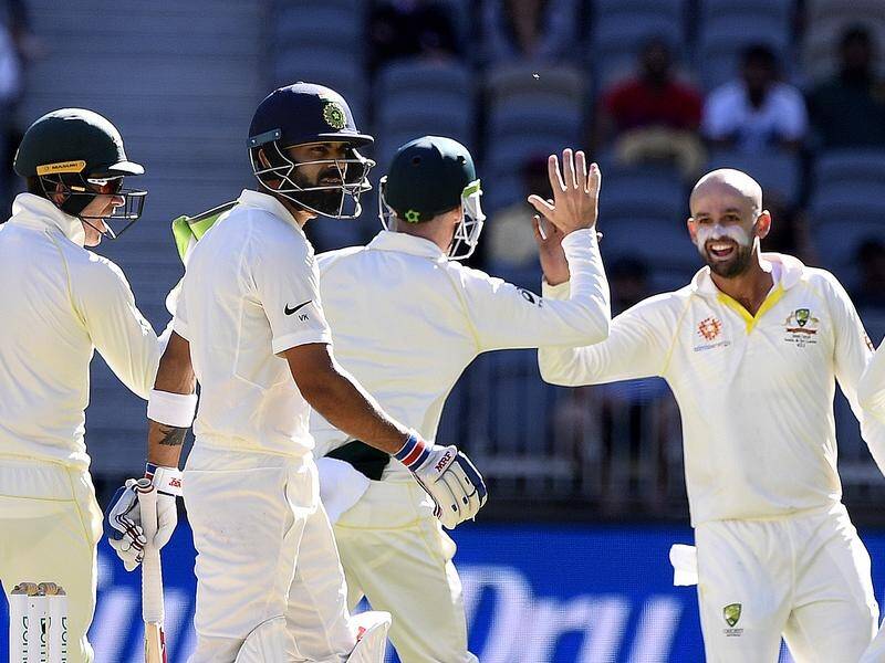 Nathan Lyon (R) has taken the prized scalp of India's Virat Kohli (2L) for 17 in the 2nd Perth Test.