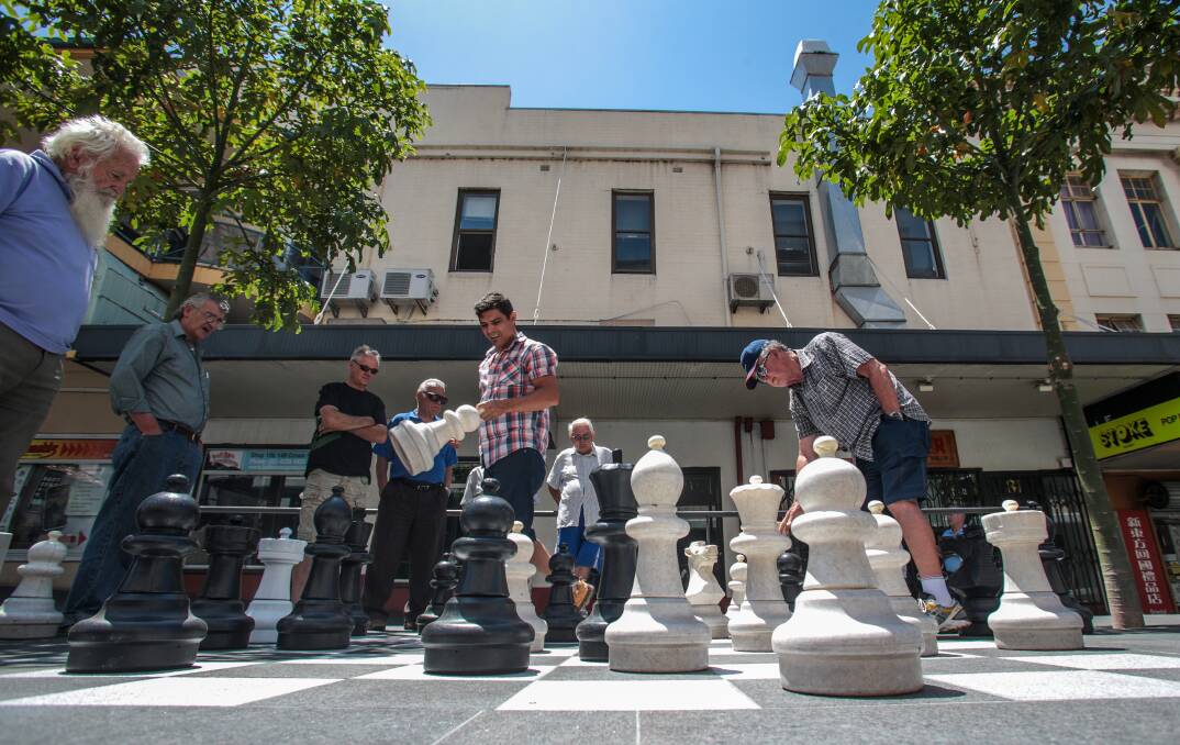 Players use the new chess board at the Wollongong Mall. Picture: ADAM McLEAN