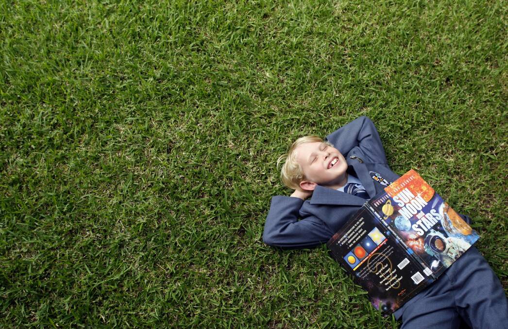 Nine-year-old Jacobus Newhouse takes a break from reading about his favourite subject - the universe. Picture: ANDY ZAKELI