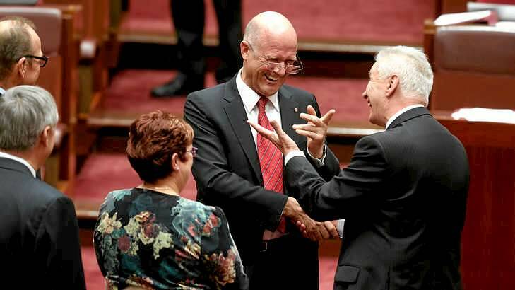 LDP Senator David Leyonhjelm is congratulated by Senator Doug Cameron after delivering his first speech in the Senate at Parliament House in Canberra. Photo: Alex Ellinghausen