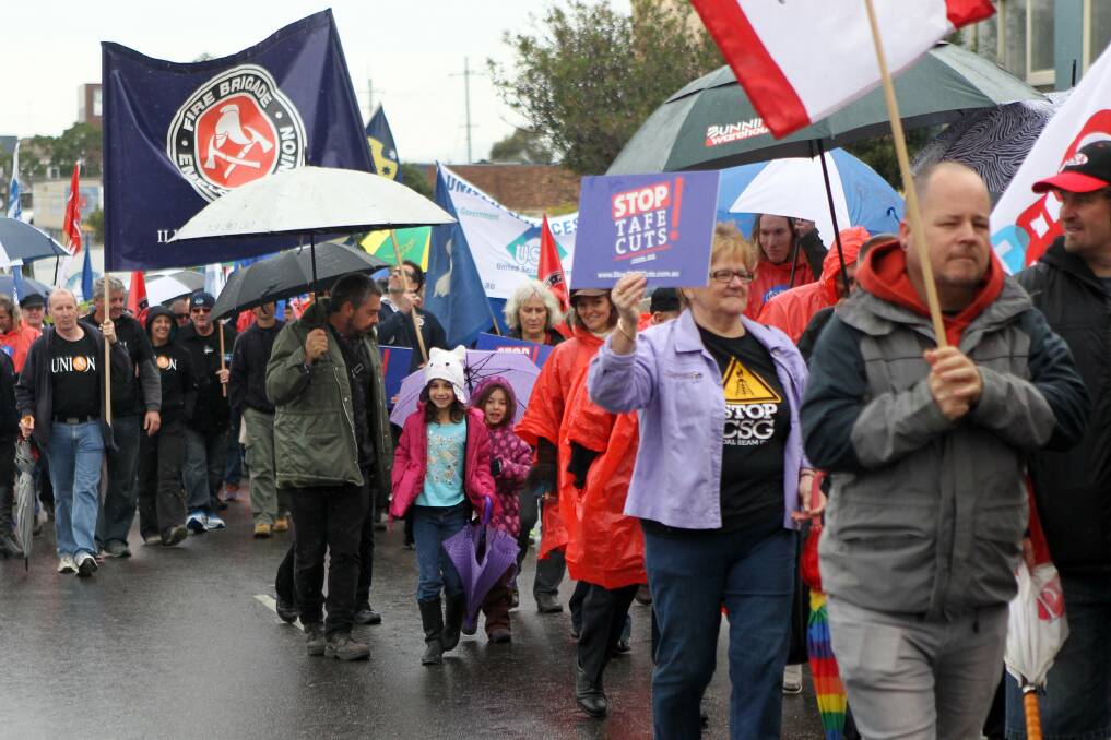 Union workers and supporters brave the rain to take part in the annual May Day march in Wollongong on Saturday. Picture: GREG TOTMAN