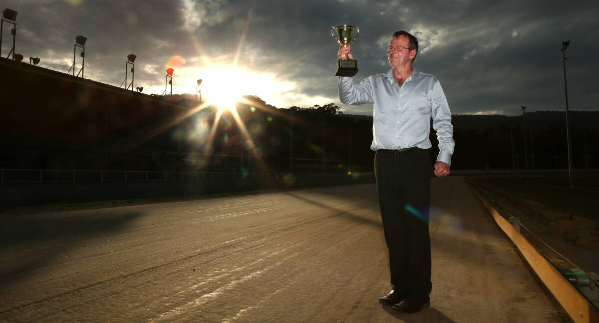 Bulli Greyhound Racing Club's racing manager Darren Hull with the Bulli Gold Cup prize on offer on Wednesday night. Picture: KIRK GILMOUR