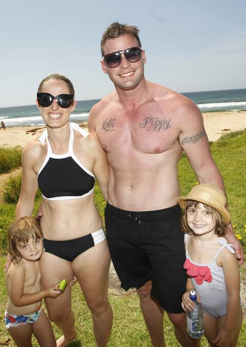 Nicole and Garry Reay, of Woonona, enjoy the beach with daughters Lola and Poppy.