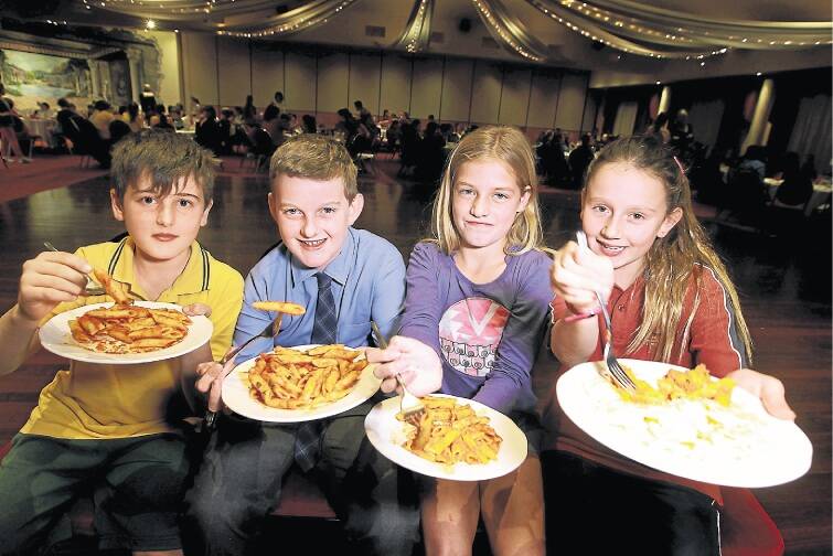 Delicious treat: Schoolchildren Muhammed Eren (left), Liam Harding, Bibi Ionannou-Marsh and Elonera Montessori enjoy a luncheon at the Fairy Meadow Fraternity Bowling Club on Wednesday as part of Italian Week festivities. Picture: SYLVIA LIBER