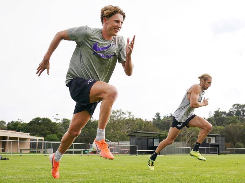 Lachie Whitfield (L) has trained with former teammates and Nick Haynes (R) during the AFL break.