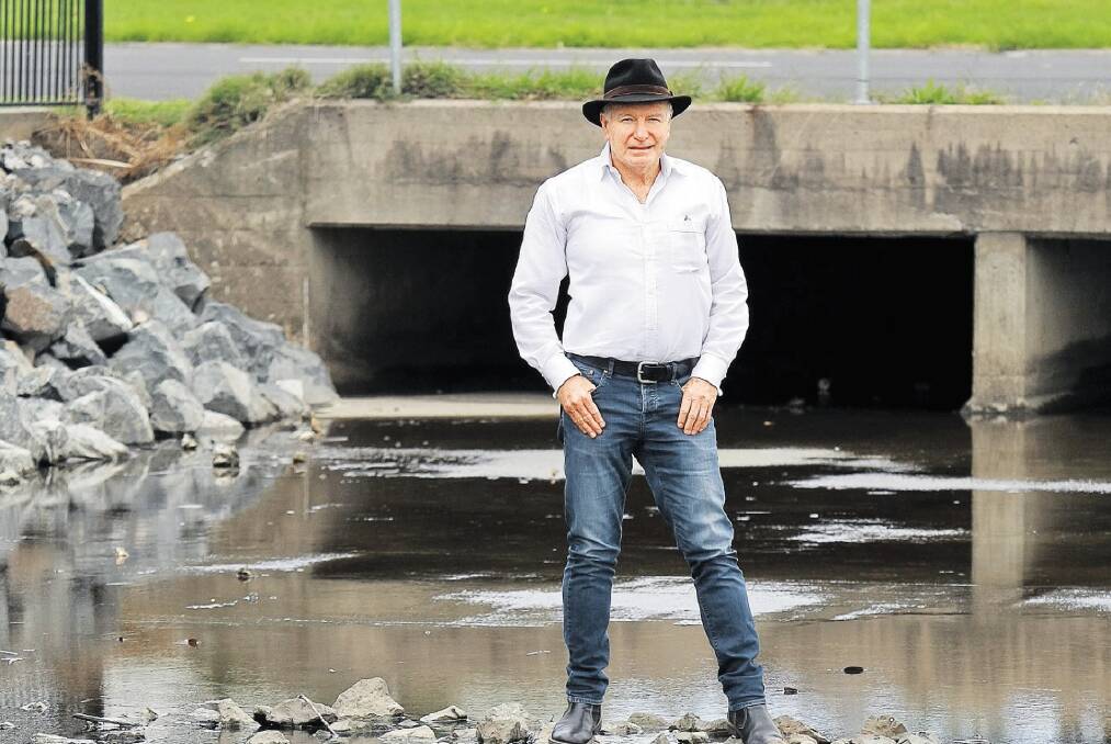 Lord Mayor Gordon Bradbery at the bridge on Swan Street, Wollongong, where the council has improved the water flow after two years of flooding. Picture: SYLVIA LIBER