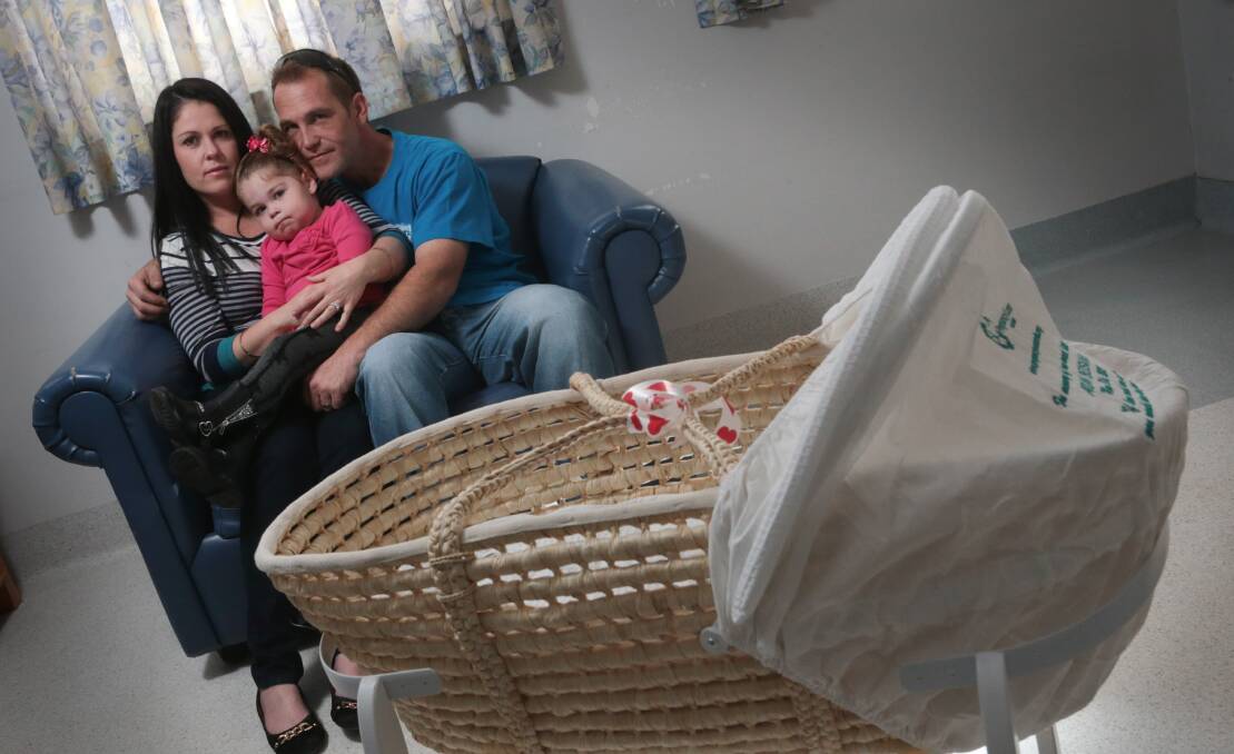 Melanie and John Bedsvaag, with Chloe, 3, and the donated cuddle cot. Picture: ADAM McLEAN