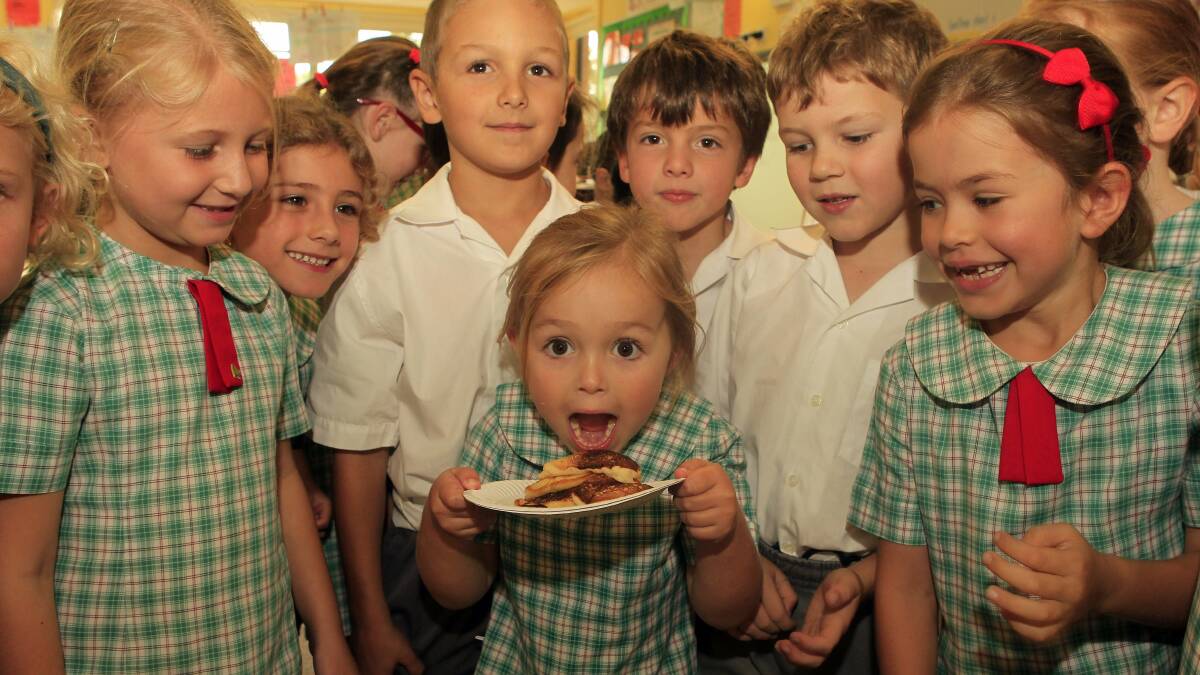 St Brigids Primary School pupil Ashleigh Jamieson, 5, tries to keep the freshly made pancakes to herself. Picture: ANDY ZAKELI