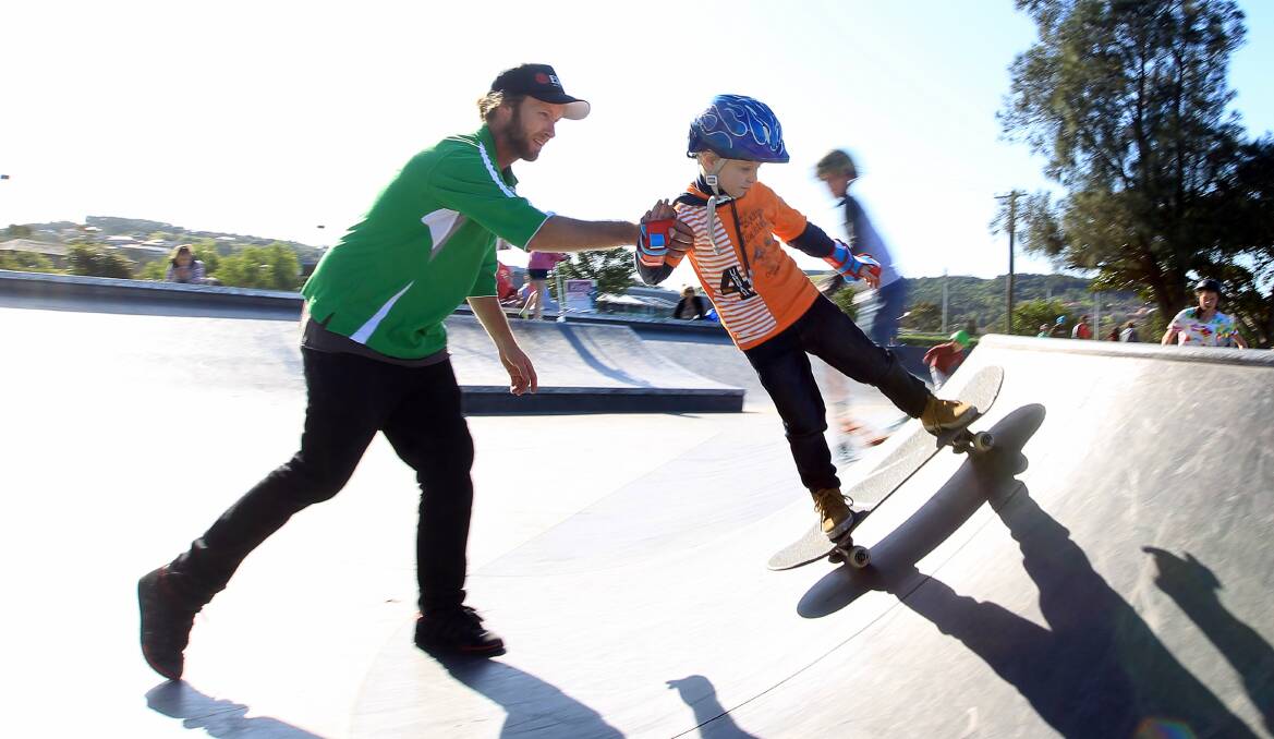 On a roll: Competitive skateboarder Matthew Carroll gives first-time skater Xavier Curtin, 5, a helping hand during a school-holiday workshop at Berkeley's skate park. Picture: SYLVIA LIBER