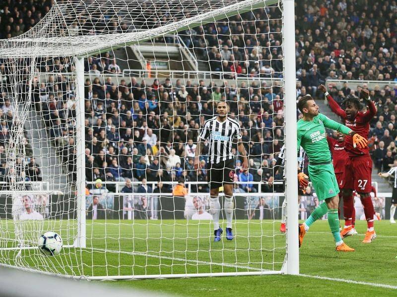 Liverpool's Divock Origi (c) celebrates his winning goal in the Premier League game at Newcastle.