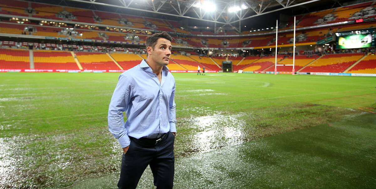 Kangaroos player Cooper Cronk inspects a water-logged Suncorp Stadium before the Anzac Test was called off on Friday. Picture: GETTY IMAGES