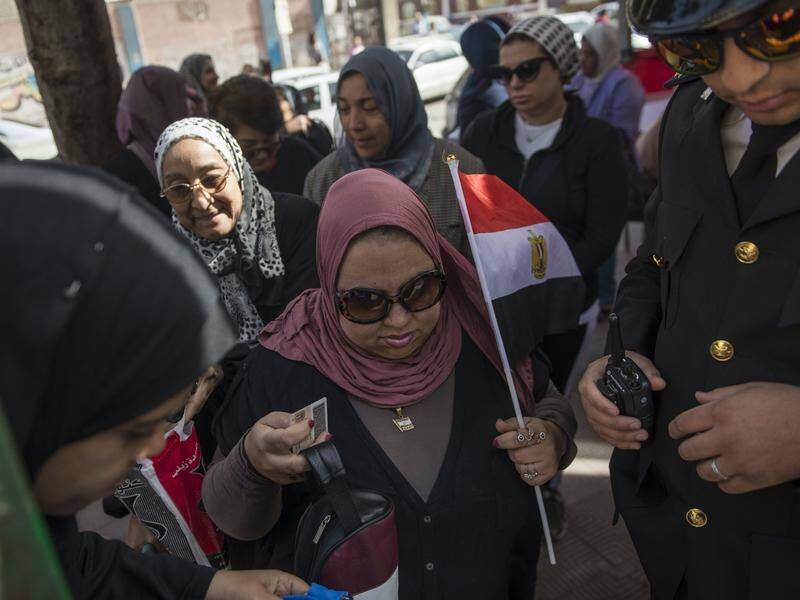 Egyptians wait outside a polling station during day one of the presidential election in Cairo.