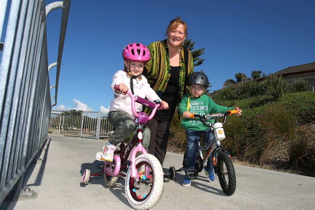 Shellharbour Mayor Marianne Saliba with young cyclists Lily Cassar, 4, and Isaac Baez, 2, both of Flinders, at Elliot Bridge, Barrack Point. Picture: GREG TOTMAN