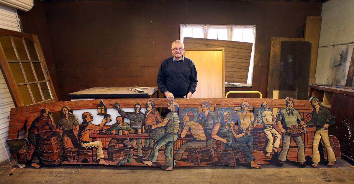 SBob Scarborough with the detailed wooden panels discovered in his father-in-law's shed at Thirroul. Picture: KIRK GILMOUR