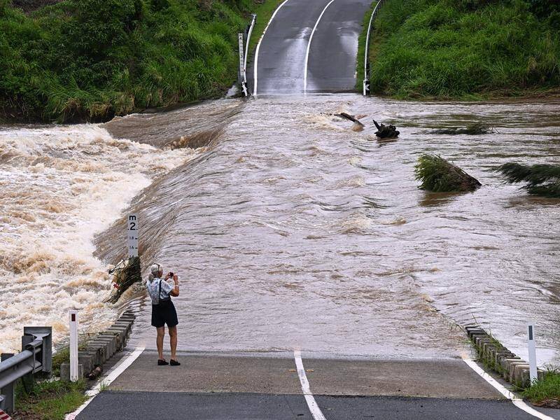 Parts of Queensland are preparing for another soaking amid calls for more resilient infrastructure. (Dave Hunt/AAP PHOTOS)