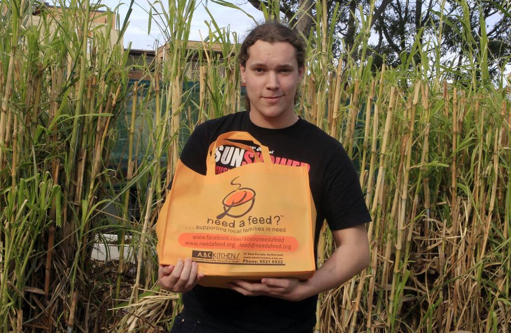 Sean Lucas, 19, with one of the Need A Feed food packs the charity will distribute to people in need next month. Mr Lucas has a 10-month-old daughter and is job hunting. Picture: ANDY ZAKELI