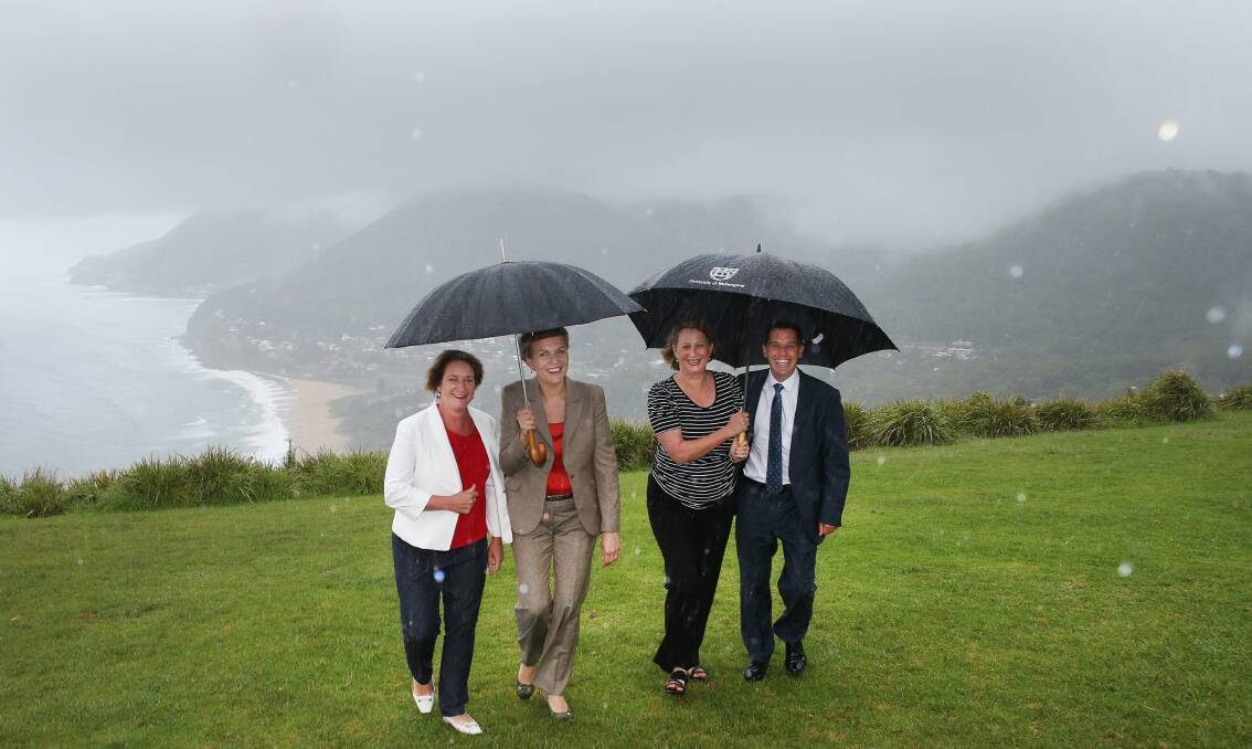Pledge: Labor candidate for Heathcote, Maryanne Stewart,    Federal member for Sydney, Tanya Plibersek, Federal member for Cunningham, Sharon Bird,  and  Keira MP Ryan Park brave the wind and rain on Bald Hill, Stanwell Park, to announce Labor’s plans for the walking track. Picture: KIRK GILMOUR