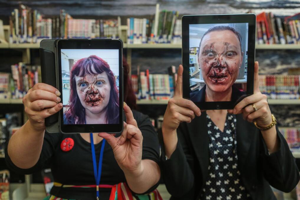 Wollongong librarians Stacey Wales and Laura Gomes put on their best zombie faces ahead of zombie film classes on July 7. Picture: ADAM McLEAN
