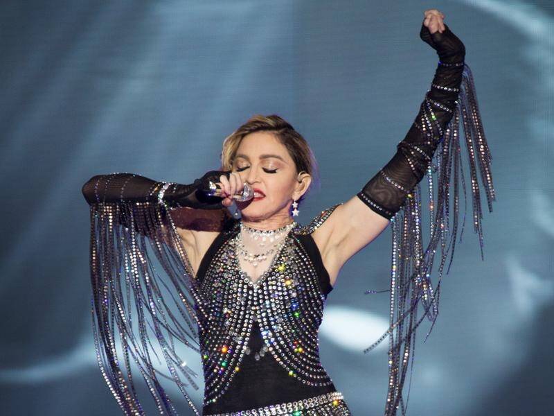 Madonna has told how she was obsessed with a producer to the point of performing witchcraft. (AP PHOTO)