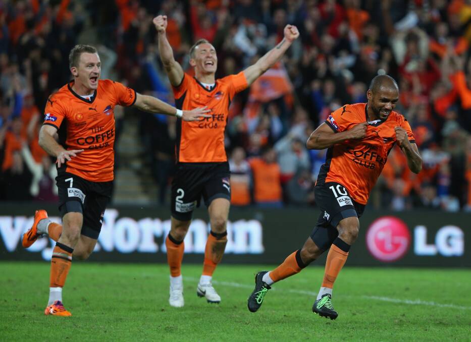 Pure bliss: Brisbane Roar's Besart Berisha, left, and Henrique, right, celebrate on Sunday night. Picture: GETTY IMAGES