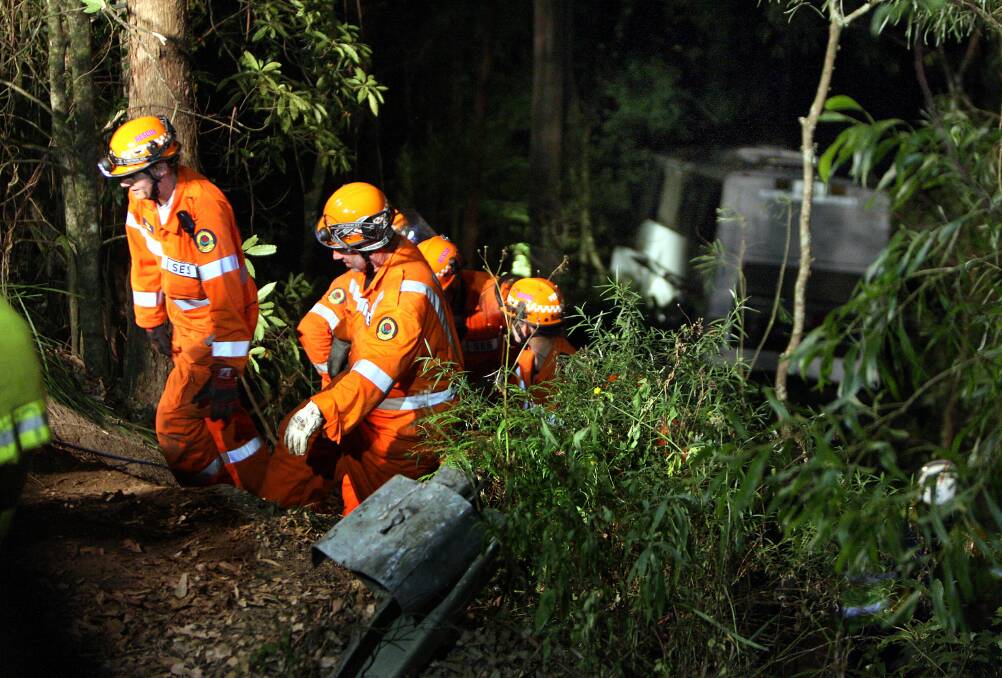 Hazardous: Rescue workers attend a serious bus crash at Barrengarry Mountain in 2010. The driver was killed and 28 others injured in the accident. Picture: ORLANDO CHIODO
