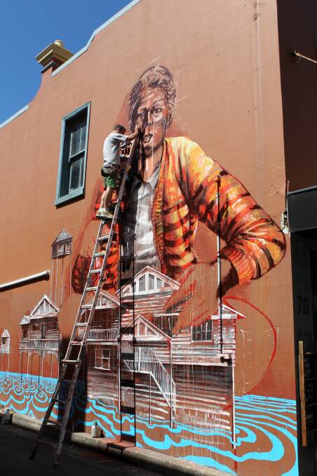 Artist Fintan McGee's painting in Wollongong's Lower Crown Street is among murals nominated for a Sydney cultural award. Picture: GREG TOTMAN