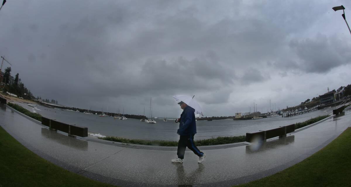 John Millington from Balgownie braves the cold, wet and windy weather along the Wollongong foreshore. Picture: ROBERT PEET