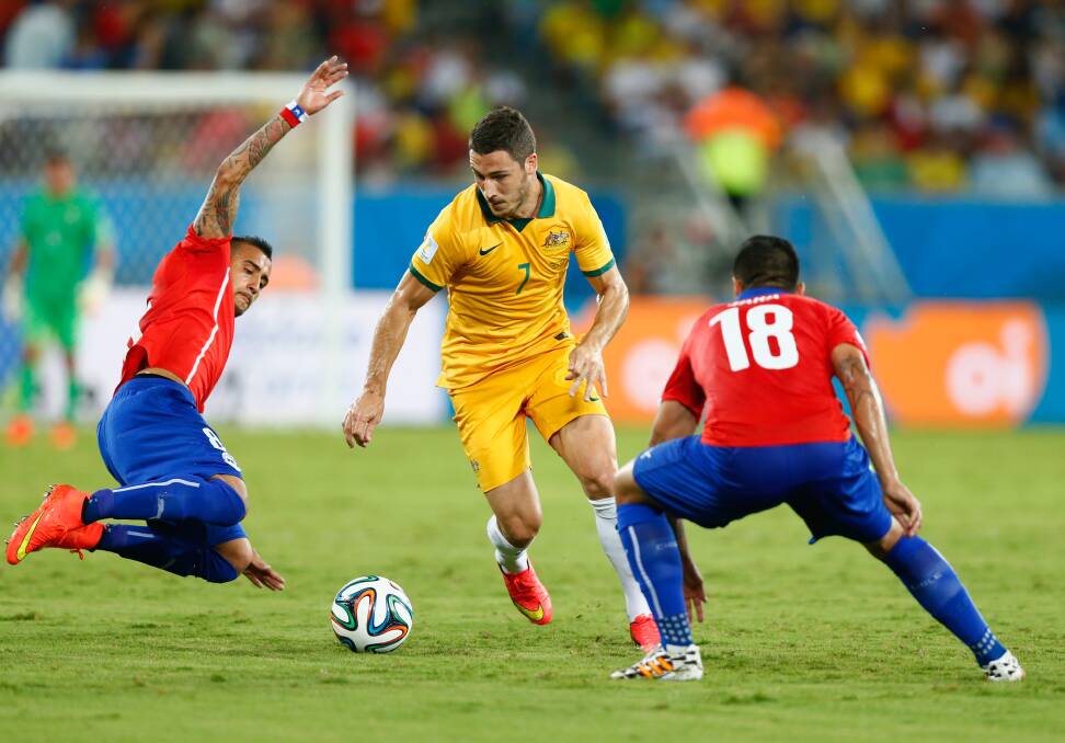 Mathew Leckie of Australia controls the ball as Arturo Vidal of Chile comes in for a tackle. Picture: GETTY IMAGES