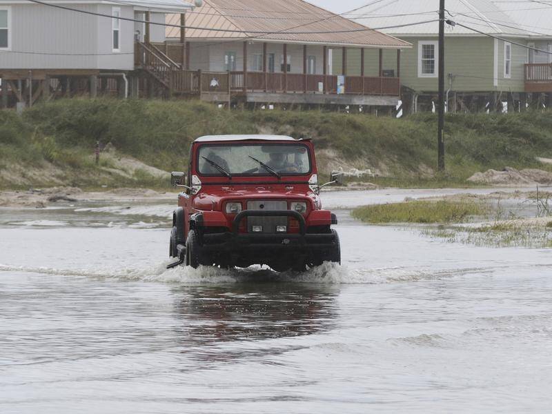 A vehicle drives through a street flooded by Tropical Storm Gordon in Alabama on Wednesday.